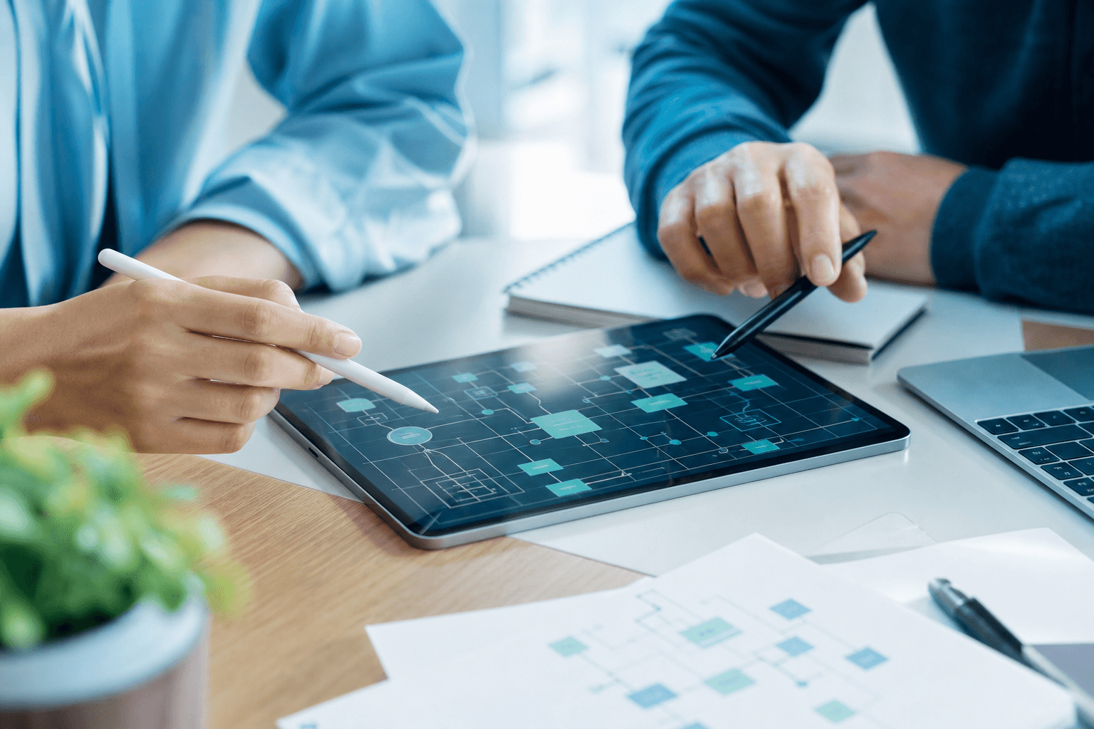 Team mapping a software system architecture on a tablet during a planning session